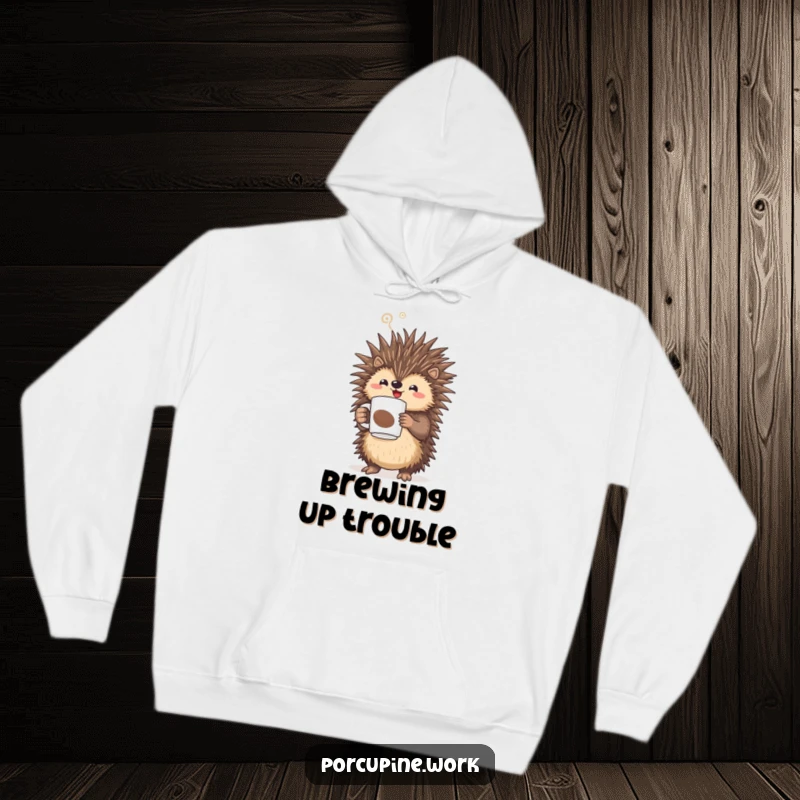 Funny porcupine triumphantly holding a steaming coffee mug, cozy hoodie for coffee lovers.