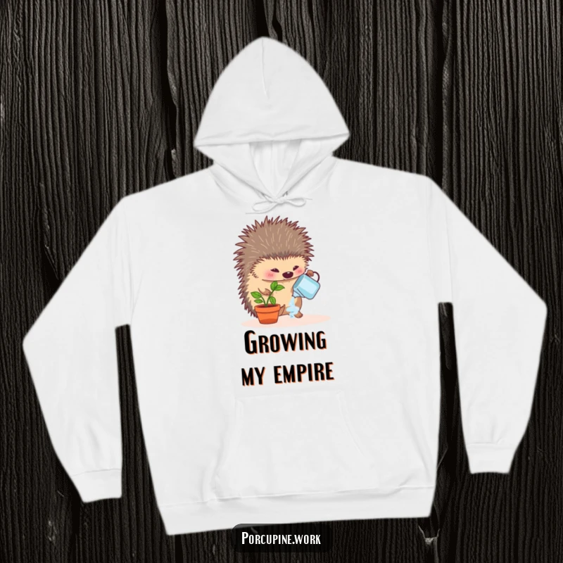 Funny hoodie showcasing a porcupine enthusiastically watering a tiny desk plant, symbolizing care, growth, and office cheer.