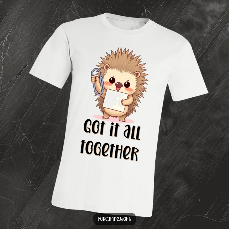 Funny porcupine proudly holds a comically oversized paperclip, beaming with a triumphant smile on this humorous t-shirt.