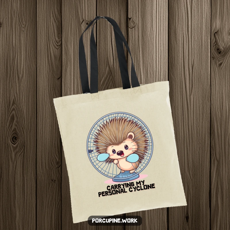 Funny tote bag with a porcupine peeking from behind a spinning office fan, perfect for carrying essentials humorously.